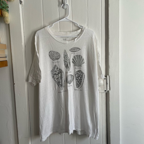 American Eagle Outfitters Tops - American Eagle Oversized White Graphic T-Shirt with Shell Design